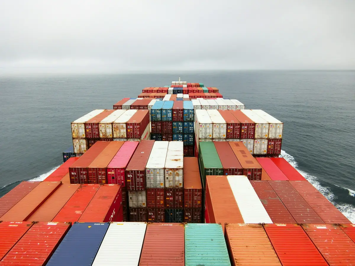 Rows of colourful containers on the deck of a ship at sea